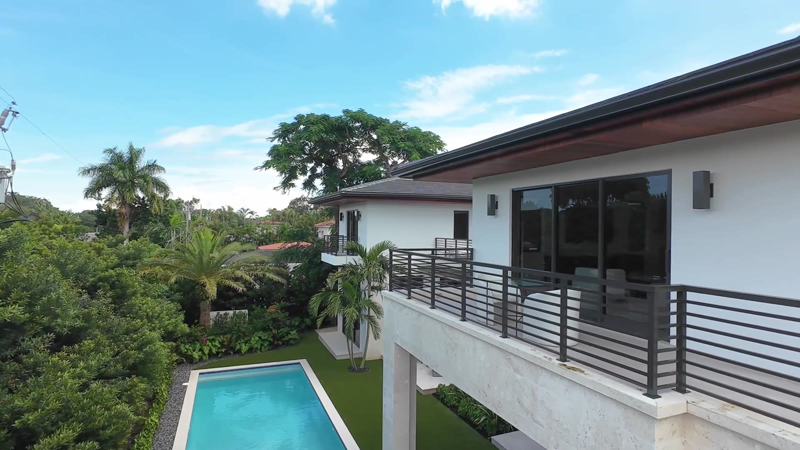 Aerial view of a modern home and pool