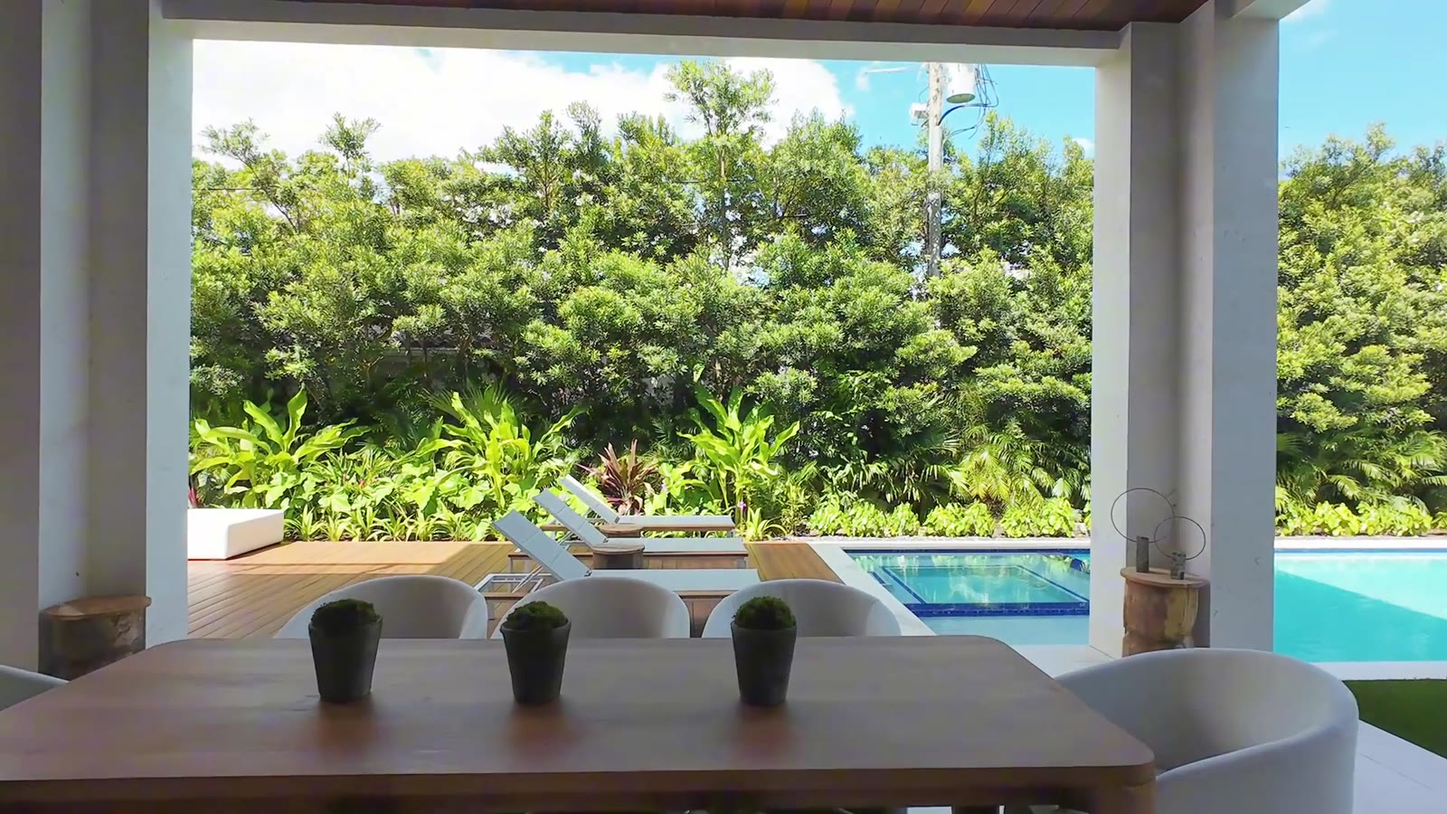Covered patio dining facing the pool