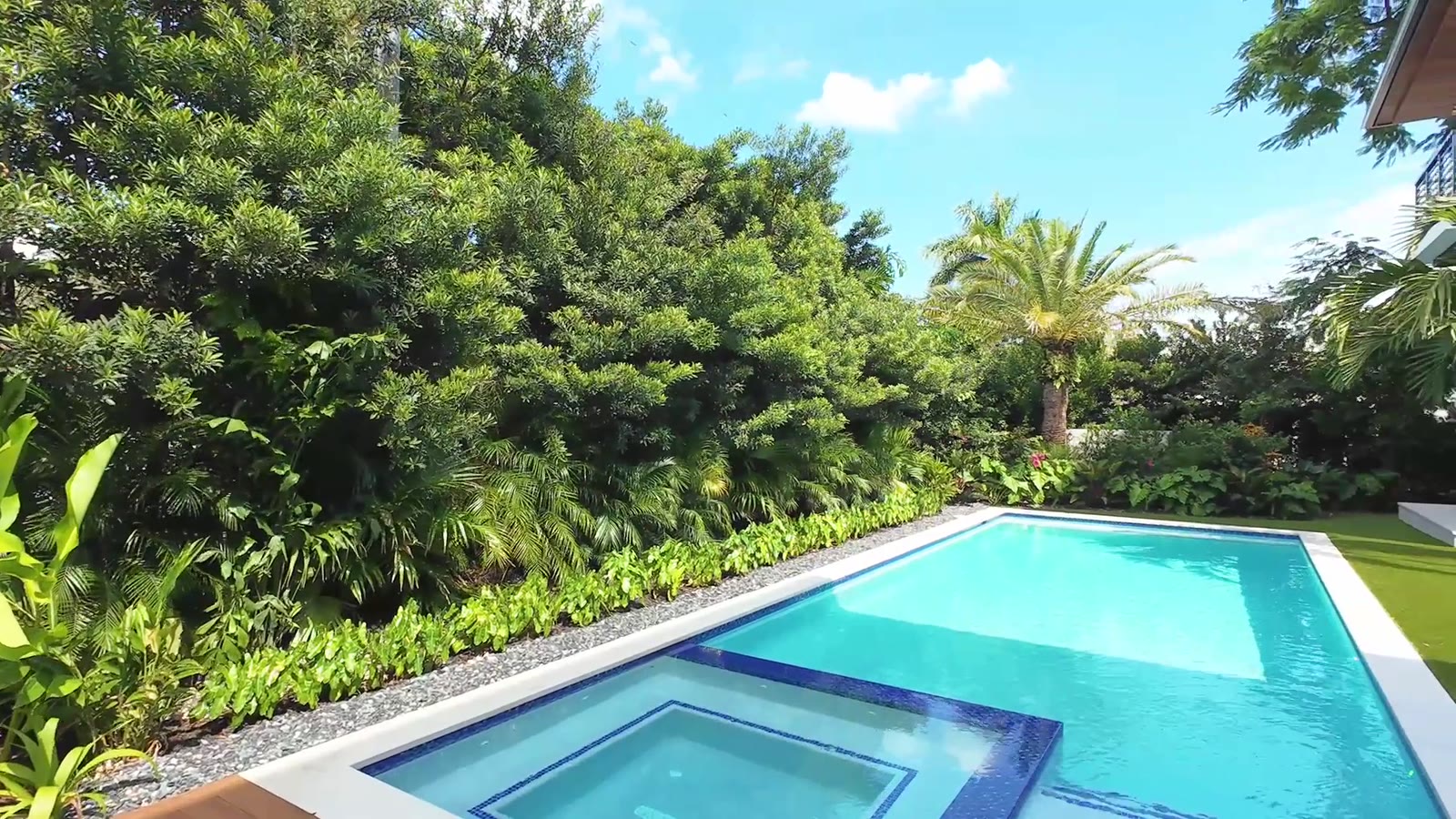 Pool and garden under a clear blue sky
