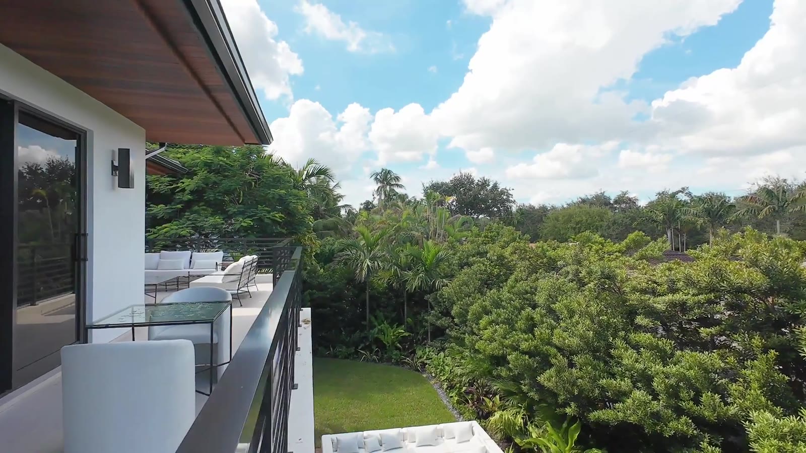 Second-floor terrace under a bright blue sky