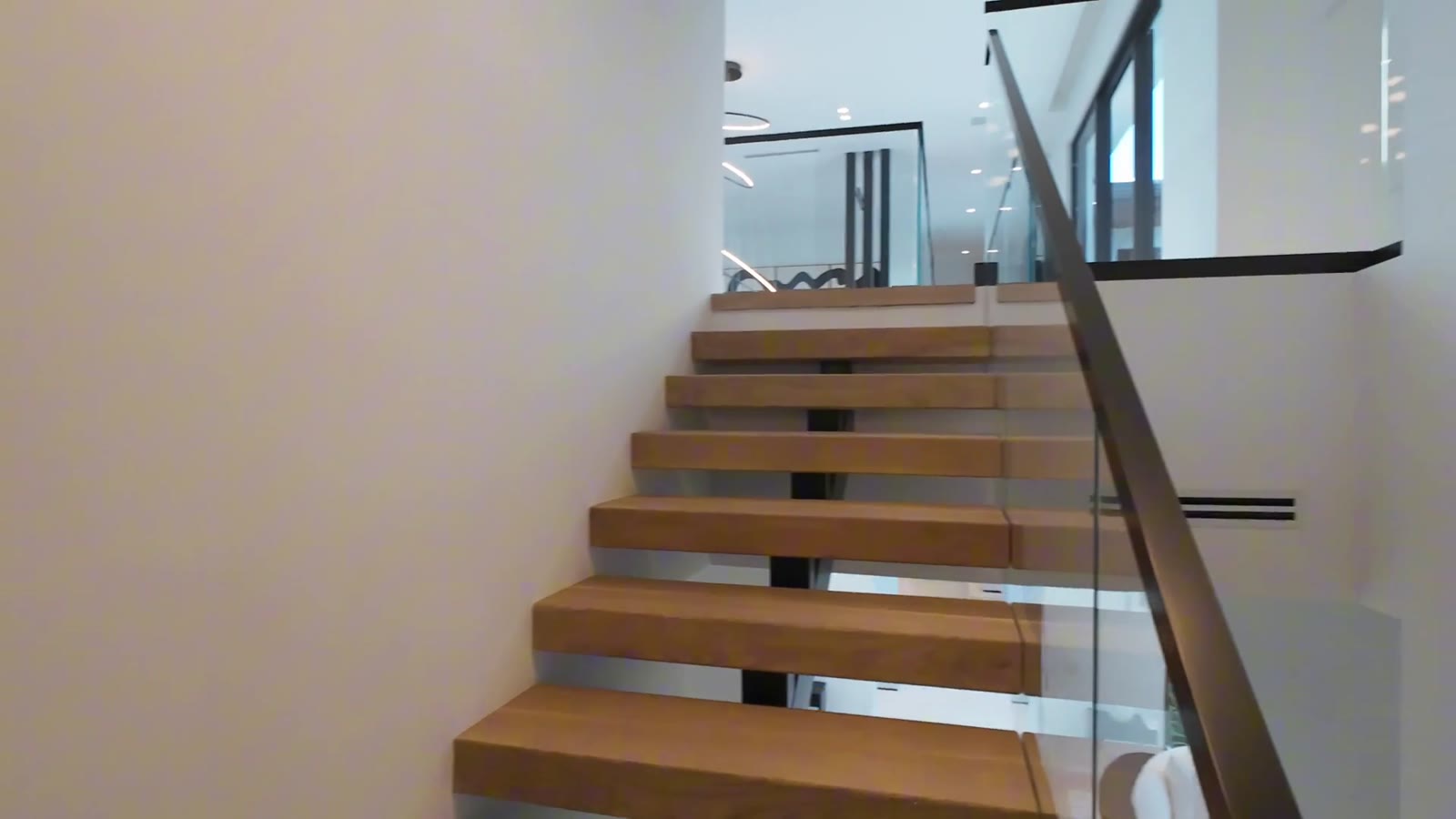 Floating wood staircase filmed in a walkthrough